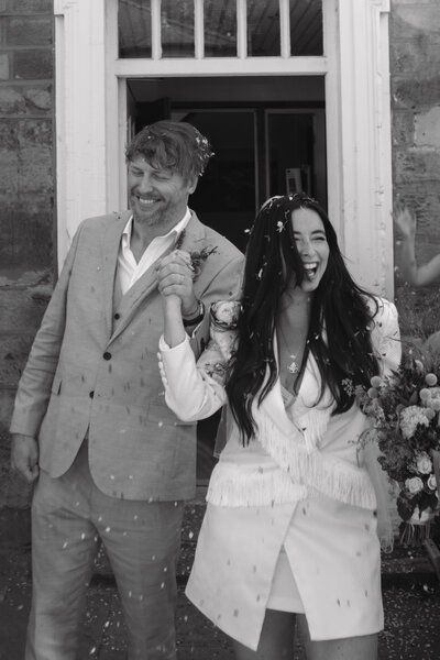 Wedding photographer captures couple taking a stroll hand in hand at their french chateau wedding.