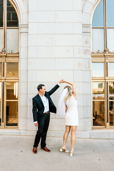 Brooke and Jeffery walking downtown with husband spinning wife around