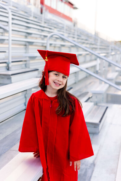 Girl in red graduation gown for Pre-school graduation