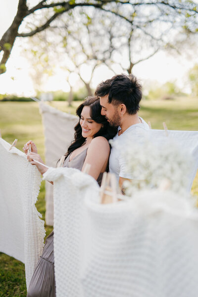 couple posing with clothesline in spring