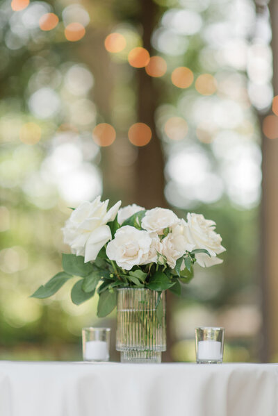 cocktail table with bud vase and flowers with candles