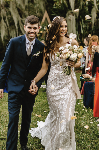 Michelle and Christian holding hands just after getting married.