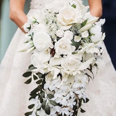 a-cascading-wedding-bouquet-with-peonies-small-and-large-roses-and-foliage-looks-refined-and-luxurious