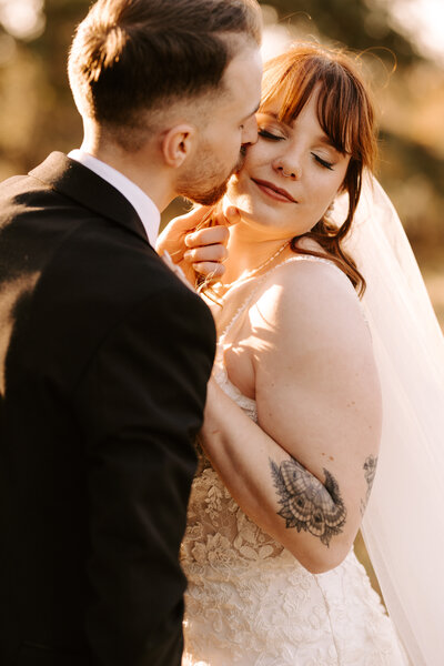 Groom softly kissing brides cheek during an elopement in Moncton