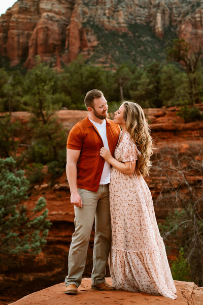 Maternity mom and husband looking at each other in Sedona, Arizona