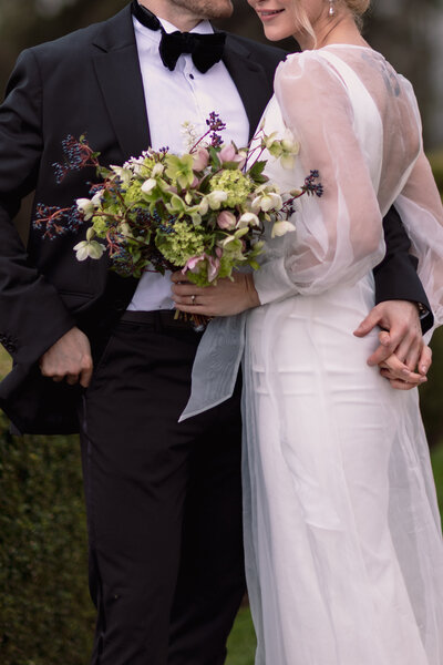 Wedding photographer captures couple taking a stroll hand in hand at their french chateau wedding.