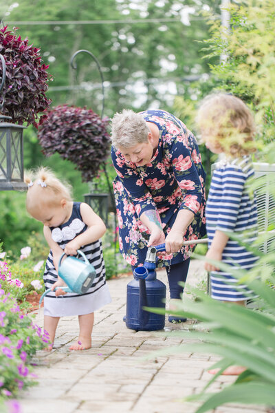 children and grandmother gardening in the spring