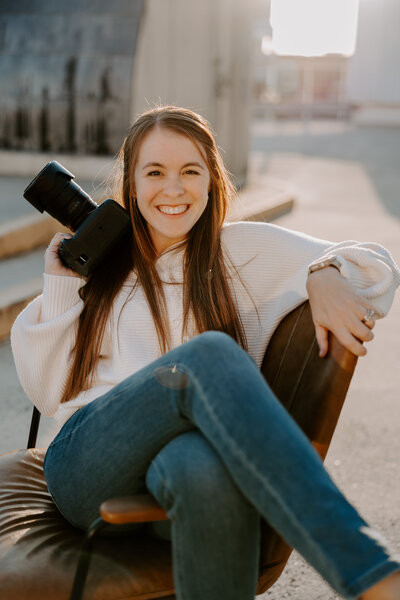 a photo of Jami Barry, a Winston-Salem wedding photographer, posing with a camera