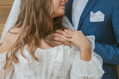 bride and groom cuddle up and hold hands