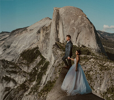 bride and groom at glacier point with half dome in the background