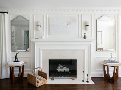 Timeless elegance meets modern design in this sophisticated living room, featuring a refined fireplace, sculptural decor, and classic paneling. Designed by Deni + Dove Interiors, serving Chatham, Essex Fells, Glen Ridge, Hohokus, Madison, Maplewood, Millburn, Mountain Lakes, Montclair, Ridgewood, Short Hills, South Orange, Summit, and surrounding NJ towns.