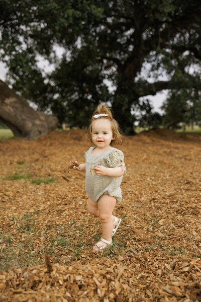 Toddler near tree at Moncus Park