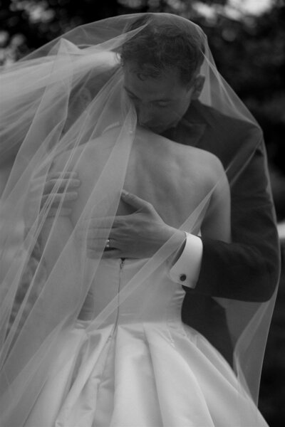 bride and groom standing on a wooden walk bridge