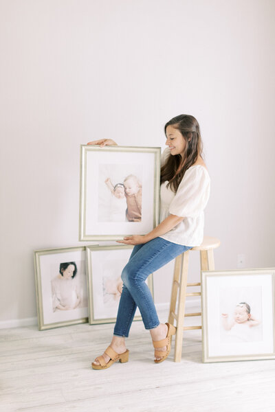 photo of Talia Laird Photography holding framed fine art prints that she custom framed for her madison wi family photography clients