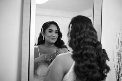 Bride smiling in mirror reflection