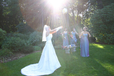 bride throws bouquet to bridesmaids
