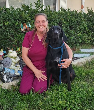 Doctor of Veterinary Medicine Tracy Anderson holding her dog