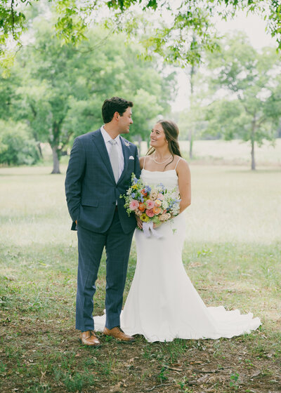 a couple in wedding attire looking into each other's eyes at The Barn at Gunn Stewart