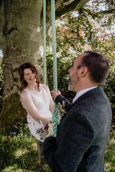 A close photography of a couple as they walk hand in hand down the aisle after their outdoors Glen Tanar wedding ceremony.