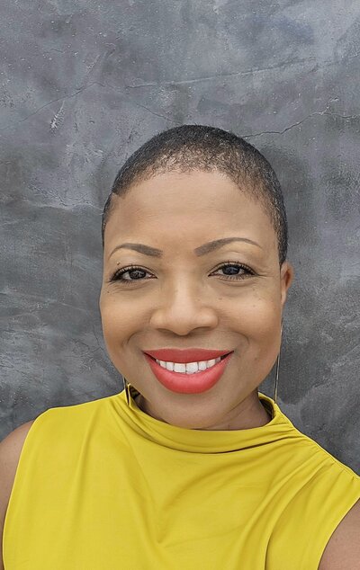 Michelle smiling in a yellow blouse