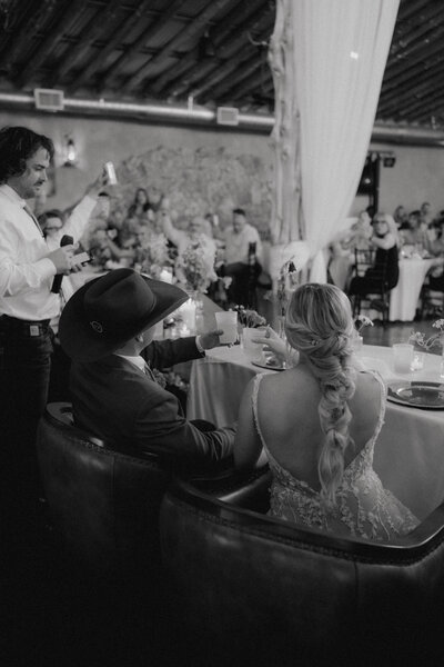 documentary style photo of bride and groom at their wedding reception
