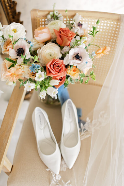 A bridal bouquet and wedding shoes decorate a wedding venue in Texas.