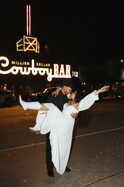 bride and groom outside of the cowboy bar
