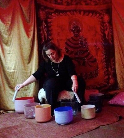 women sitting on the floor with sound healing bowls