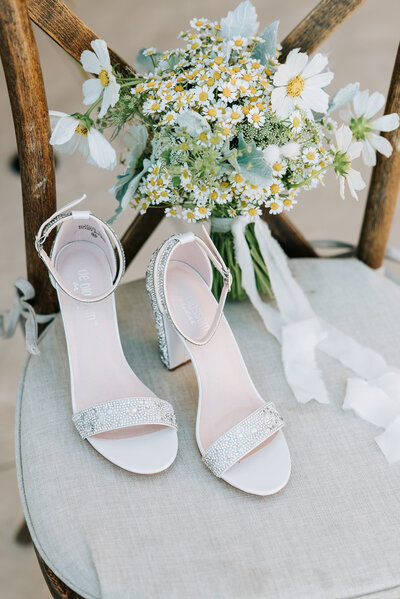 bride's wedding day details outside on ceremony chair