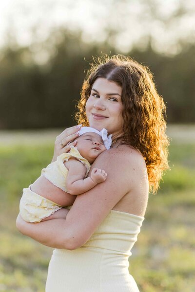 Mom holds infant daughter against her chest