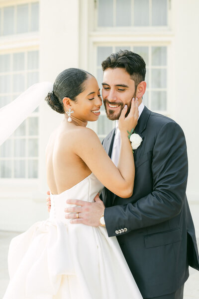 bride and groom cuddling outside grand galvez