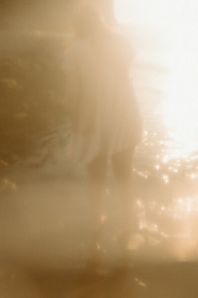 Girl dancing in water at sunset on Oregon Coast