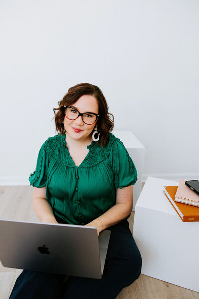 Copywriter Sara Gillis sitting on a yellow chair