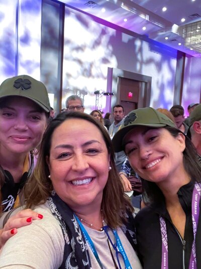 Marita Choque smiling with colleagues at a leadership conference, capturing community, joy, and professional connection.