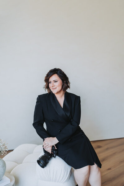 woman holding the camera while sitting on a chair