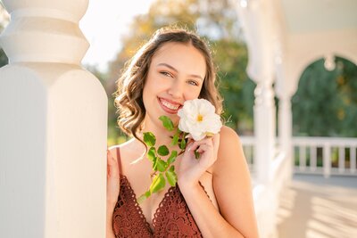 High school senior girl holding a white rose by Livermore senior photographer Kristen Hazelton