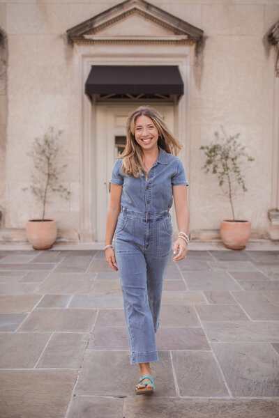 Ellie, of EK Creative, walking and smiling at camera