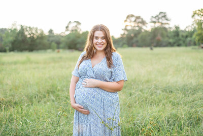 pregnant woman and husband walking in maternity photos