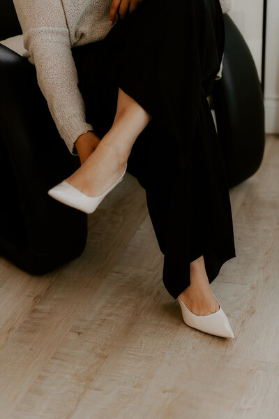 woman wearing black pants and white heals 