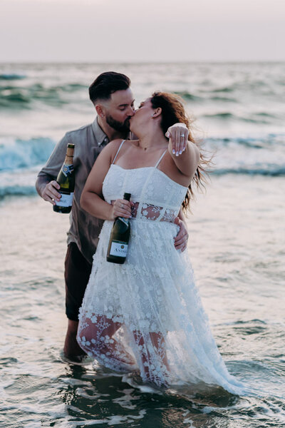 newly engaged couple kissing during their st pete beach engagement session