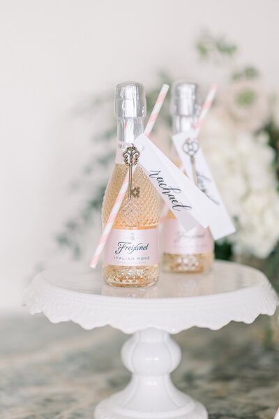 Two mini champagne bottles with custom calligraphy name tags