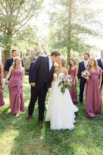 A bride shares a moment with her sisters and bridesmaids as she prepares for a first look with her groom on her wedding day