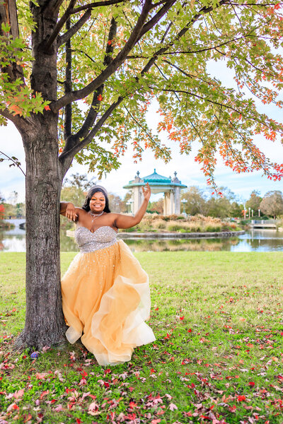 Arissa underneath a tree in front of the pagoda in forest park in the fall