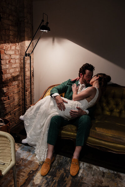 Newlyweds kiss in front of Sts. Peter and Paul Church in the Soulard Neighborhood of St. Louis, Missouri. The church can be seen towering in the background.