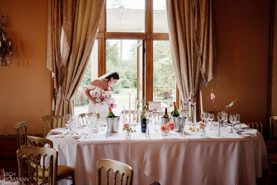 Bride in sitting down for the wedding breakfast at Orchardleigh Estate