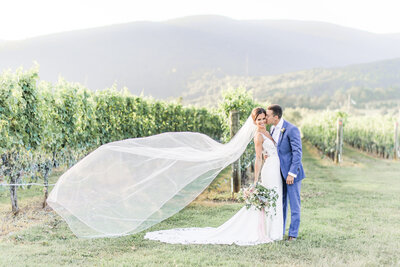 Couple kissing at the alter at King Family Vineyard while paper airplanes swirl around them.