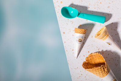 Ice Cream Cones and scooper on White Spotted Background - Daylight Donuts