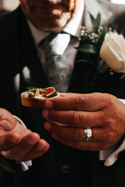 Wedding guest enjoying canapé from Nouré & Co service