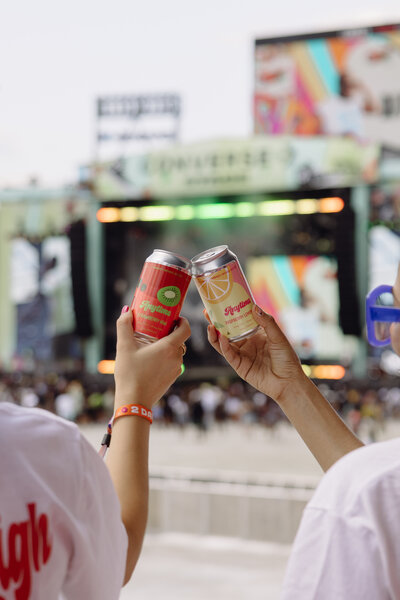 Close up images of seltzer cans at a live concert event