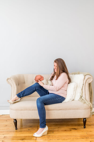 baby girl with big sisters at newborn photo shoot